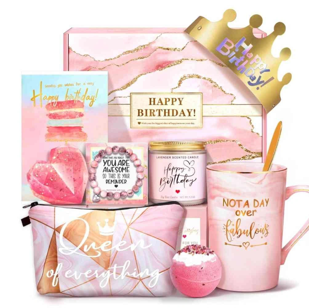 Complete pink birthday gift set for women with 'Not a Day Over Fabulous' mug, candle, makeup bag, crown, and soap