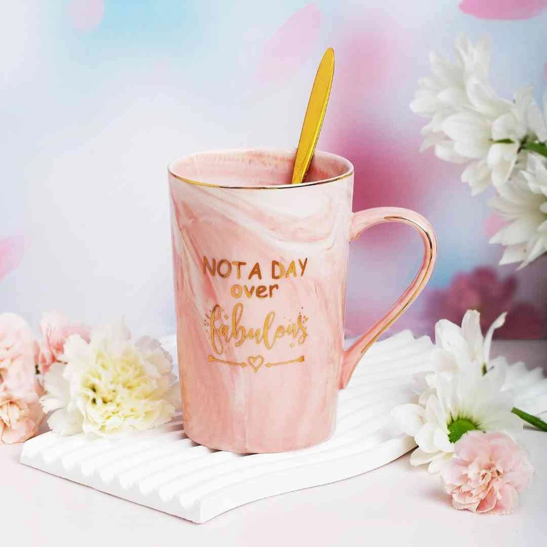 Pink marble mug with 'Not a Day Over Fabulous' text, ideal birthday gift for women, part of a luxurious gift set.