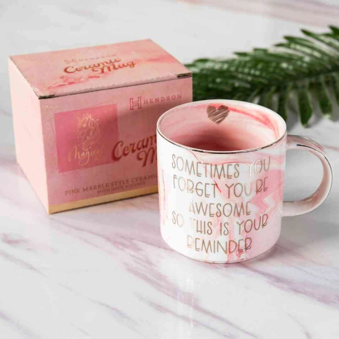 Close-up of a pink marble coffee mug with the motivational quote "Sometimes You Forget You’re Awesome So This is Your Reminder.