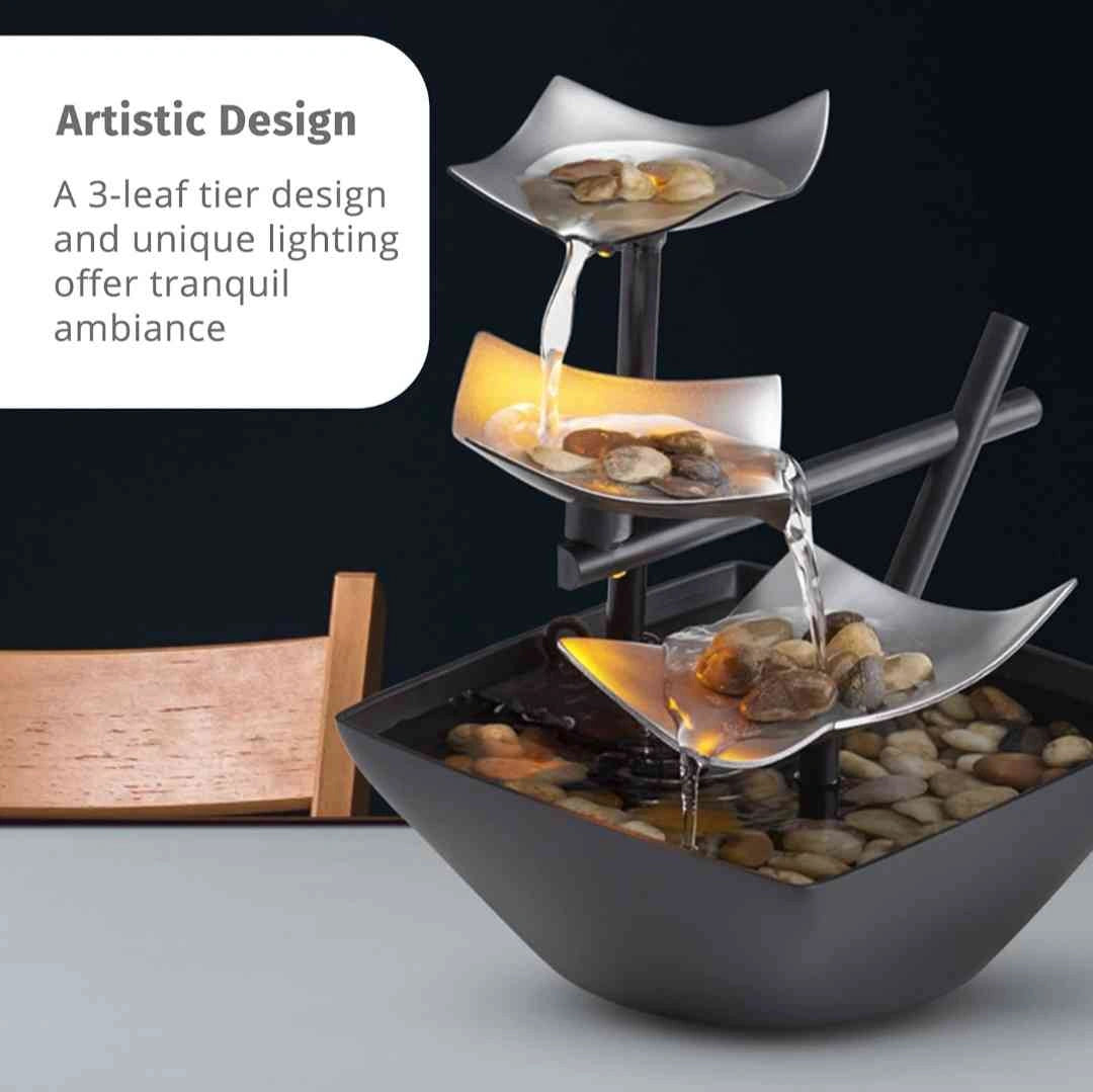 Three-tier tabletop fountain with artistic leaf design and gentle lighting, ideal for a calming ambiance at home or office.